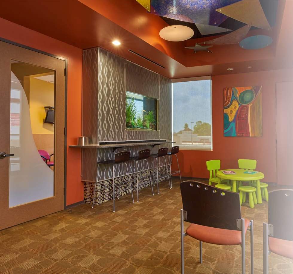 Colorful waiting room with child-sized tables and chairs at Memorial Pediatric Dentistry